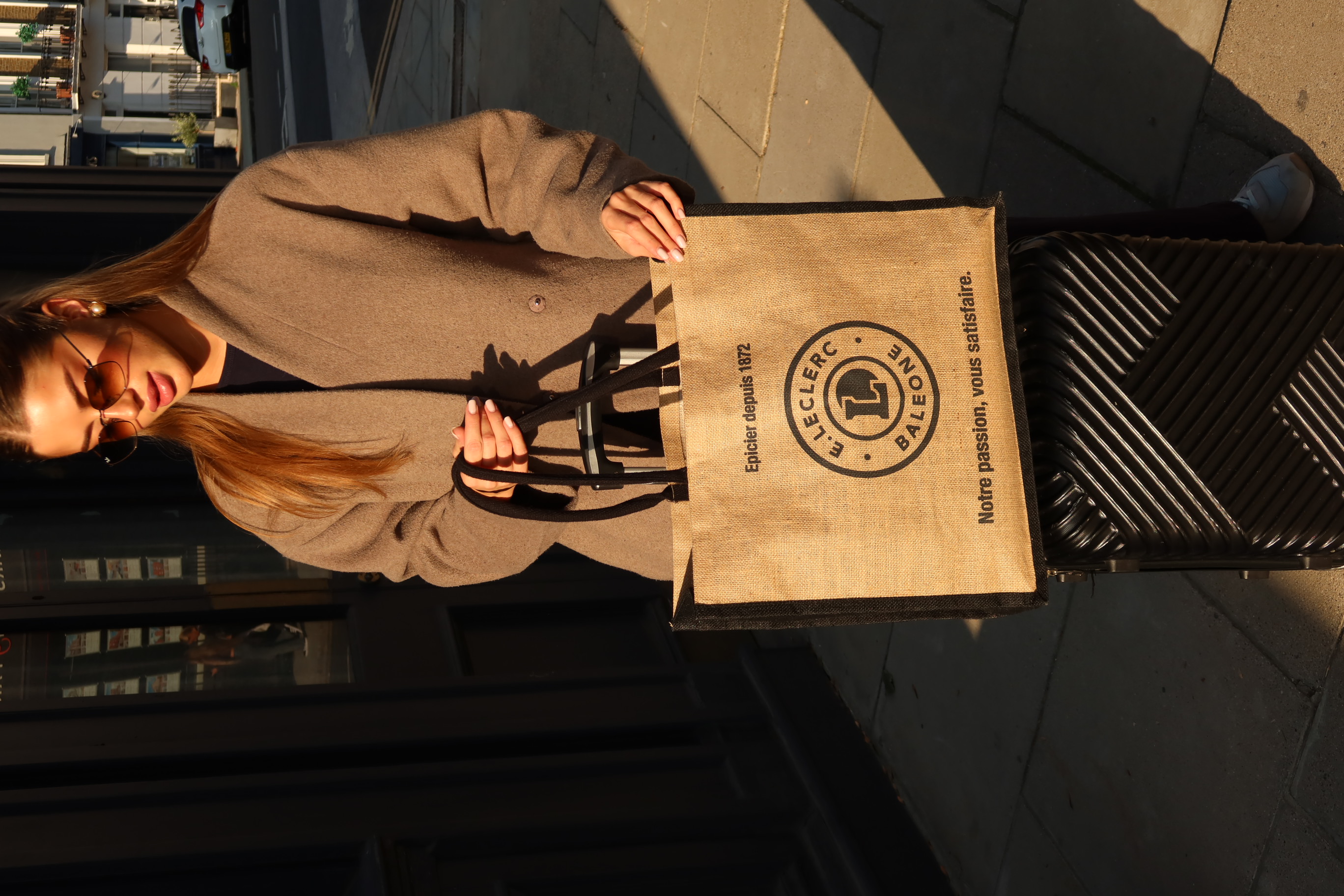 Woman holding jute bag in golden hour light